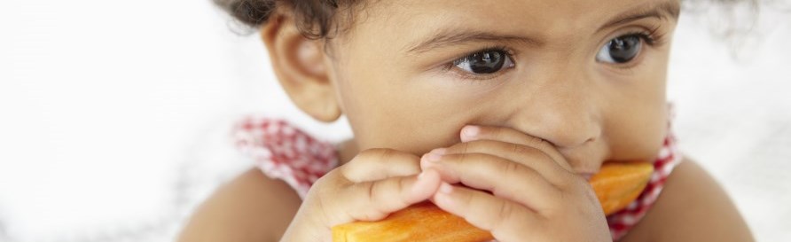 Young girl eating carrot